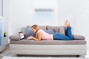 woman happy with her new air conditioner cost