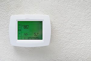 a picture of a thermostat that also doubles as a humidistat showing a really high percentage of humidity in the air which affects the indoor air quality of the home